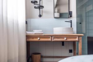 a bathroom with a wooden table with a sink at Loom in Bolzano