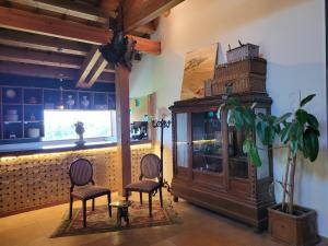 a room with two chairs and a cabinet and a plant at El Mirador del Chispano in Ayllón