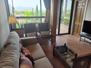 a living room with a couch and a table at El Mirador del Chispano in Ayllón