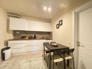 a kitchen with a table and chairs in a room at CoolKush Boutique in Constanţa +58 photos