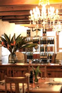 a bar with a vase of flowers on a table at Jan Harmsgat Country House in Swellendam