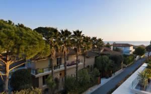 an aerial view of a building with palm trees at The Magic Forte in Forte dei Marmi