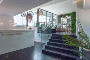 a lobby of a building with stairs and a restaurant at Trendy Bachelor Pad Free Parking Rooftop Pool in Cape Town
