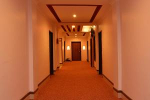 a hallway with a long corridor with white walls at Hotel Marshyangdi in Kathmandu