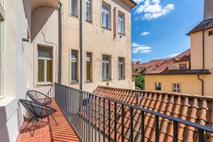 a balcony of a building with two chairs at Celetná 12 - Old Town Residence in Prague