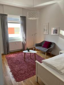 a bedroom with a bed and a couch and a table at Feel-Good Apartment In Mannheim-Neckarau in Mannheim