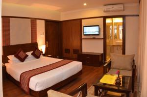 a hotel room with a bed and a television at Hotel Marshyangdi in Kathmandu