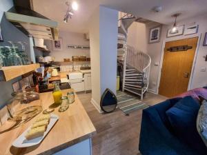 a kitchen and a living room with a spiral staircase at Stunning Luxury Vintage Duplex with Parking in Manchester