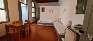 a kitchen and dining room with a table and chairs at Vecchio Hotel in Rethymno Town