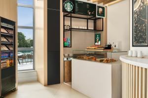 a kitchen with a counter with some pastries on it at Holiday Inn Birmingham Airport - NEC by IHG in Bickenhill +82 photos