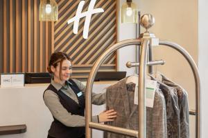 a woman standing next to a mannequin in a store at Holiday Inn Birmingham Airport - NEC, an IHG Hotel in Bickenhill