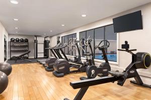 a gym with treadmills and elliptical machines at Holiday Inn Birmingham Airport - NEC by IHG in Bickenhill