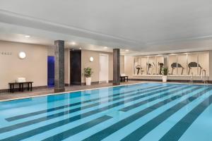 a swimming pool with a swimming pool table and chairs at Holiday Inn Birmingham Airport - NEC, an IHG Hotel in Bickenhill