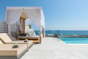 a villa with a pool and a bedroom with a view at Villa Auretta in Pefki Rhodes