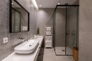 a bathroom with two sinks and a shower at Villa Auretta in Pefki Rhodes