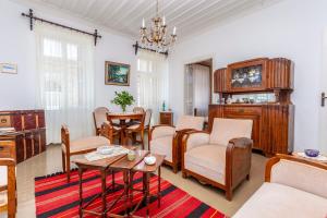 a living room with wooden furniture and a table at SOTIRIA in Pythagoreio