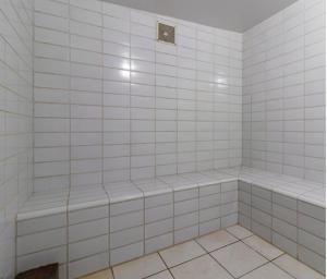 a bathroom with white tiled walls and a shower at Loft no coração da cidade de Blumenau in Blumenau +14 photos
