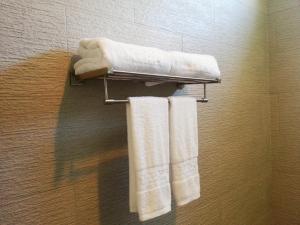 a bathroom with white towels on a towel rack at El Nido Bayview Resort in El Nido