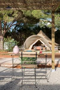 stół piknikowy z namiotem w tle w obiekcie Glamping La Mimosa CONIL w mieście Conil de la Frontera