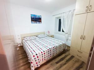 a white bedroom with a bed and a window at Guesthouse Moreta in Vodice