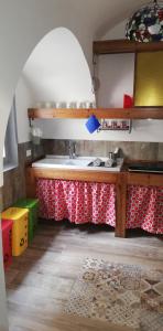a kitchen with a table and a sink in a room at CASA DI 'NZUSU in Carovigno