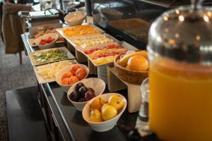 a buffet line with many different types of food at Cala di Volpe Boutique Hotel in Montevideo