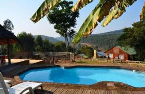 a large blue swimming pool with a view of the mountains at Mulberry Lane in Richmond