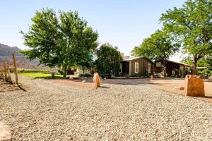 a gravel driveway with rocks in front of a house at Spanish Valley Vinyard in Moab