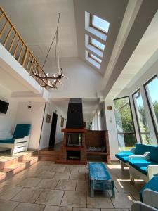 a living room with blue chairs and a chandelier at Pensiunea Sandra in Bran
