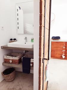 a bathroom with a sink and a mirror at Les Terrasses du Bénitier in La Gaulette