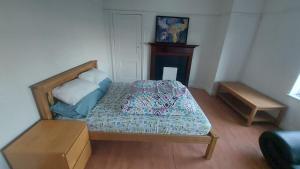 a small bedroom with a bed with a box at London Edgware Station Apartment in London