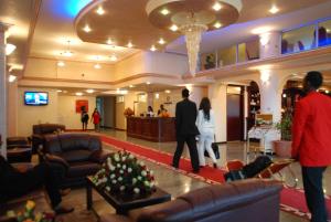 a group of people walking around a lobby at Kaleb Hotel in Addis Ababa
