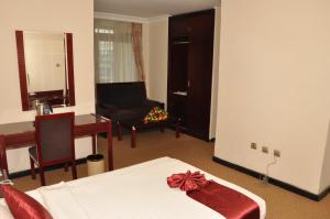 a bedroom with a bed with a bow on it at Kaleb Hotel in Addis Ababa