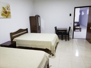 Ένα ή περισσότερα κρεβάτια σε δωμάτιο στο Estudio Recanto do Teimoso