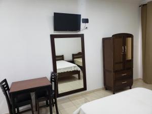 Ένα ή περισσότερα κρεβάτια σε δωμάτιο στο Estudio Recanto do Teimoso +3 φωτογραφίες