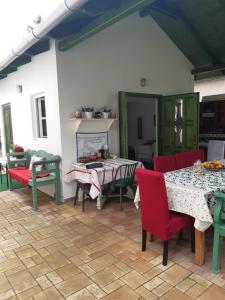 a patio with tables and chairs in a room at Rebeka Villa in Zamárdi