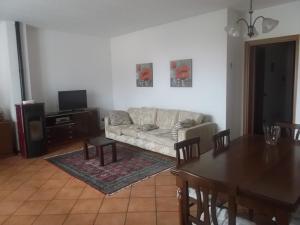 a living room with a couch and a table at Crespi House in Parabiago