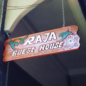 a sign that reads raa almost house hanging from a chain at Raja Guest House - Jungle Trekking & Tours Bukit Lawang Sumatra in Bukit Lawang