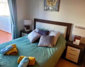 a bedroom with a bed with two pillows on it at JARDIN 8 JOZMAR in Alhama de Murcia +27 photos