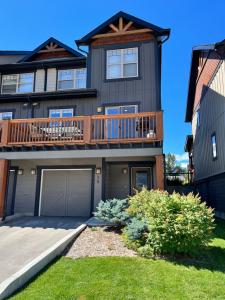 a large house with a deck on top of it at Perfect base Invermere 3bd townhouse mt views with garage in Invermere