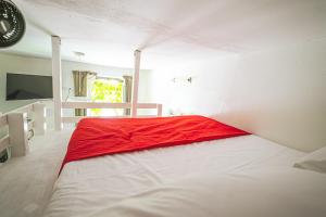 a bedroom with a large bed with a red blanket at AvocadoHouse2VistaTerme in San Pellegrino Terme
