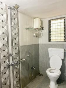 a bathroom with a toilet and a shower at Seashore Holiday Home in Revadanda