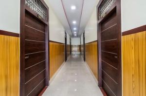 a corridor with wooden doors in a hallway at Seashore Holiday Home in Revadanda