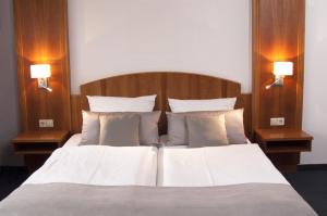 a bedroom with a large bed with two night stands at Hotel Germania in Reutlingen +18 photos