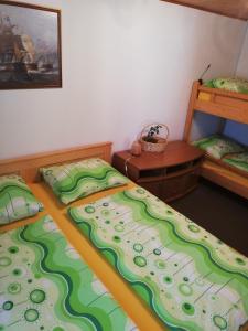 two twin beds in a room with a bedskirts at Apartma pri Bregarju in Bohinj