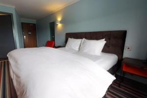 a large white bed in a hotel room at Village Hotel Newcastle in Newcastle upon Tyne