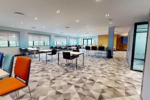 a conference room with tables and chairs in a building at Village Hotel Newcastle in Newcastle upon Tyne