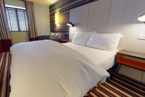 a large white bed in a hotel room at Village Hotel Newcastle in Newcastle upon Tyne