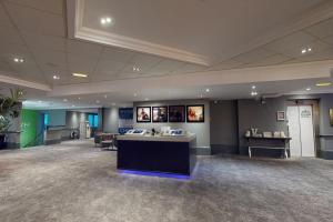 a waiting room with a reception desk in a building at Village Hotel Newcastle in Newcastle upon Tyne