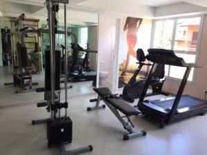 a room with a gym with a woman in the mirror at Lazer completo 150 mts praia - apto novo Maitinga in Bertioga